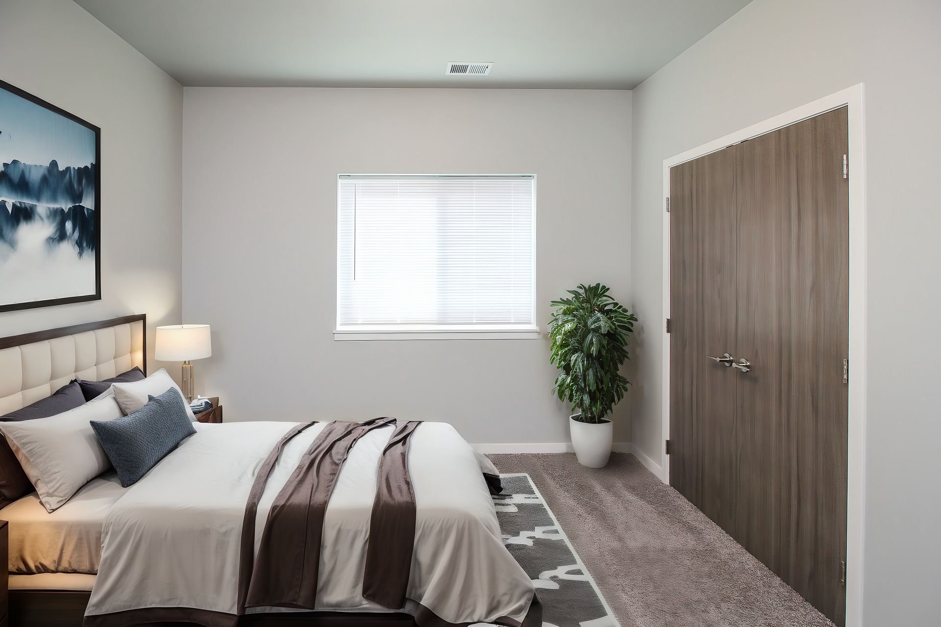 Bright modern bedroom with a bed, window, potted plant, and closet doors