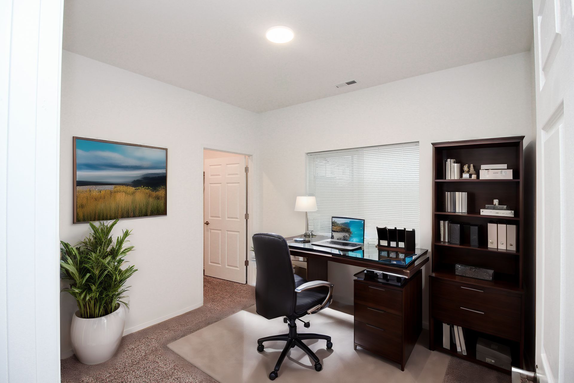 Home office with desk, chair, bookshelf, window blinds, and a potted plant in a bright white room