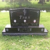 A polished black granite headstone with the name 