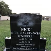 Black granite memorial headstone for Nickolas Francis Tenerelli (1990–2017) with a portrait engraving in a cemetery.