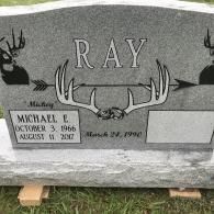 A gray granite gravestone engraved with 