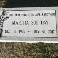 A gray granite gravestone for Martha Sue Day, dated October 18, 1925, to July 31, 2017, with a cross design on the left.