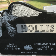 Black upright headstone with an engraved angel, the name 