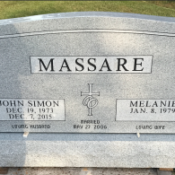 A grey granite headstone for the Massare family, inscribed with dates for John Simon and Melanie, and a marriage date.