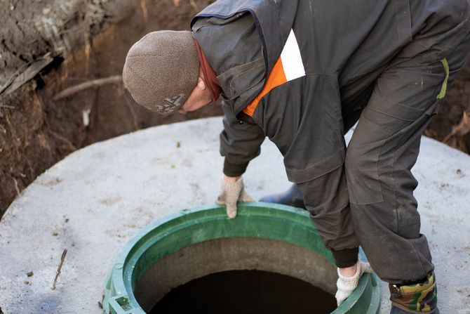 A Man Installs A Sewer Manhole — Madison, GA — G & H Septic Service