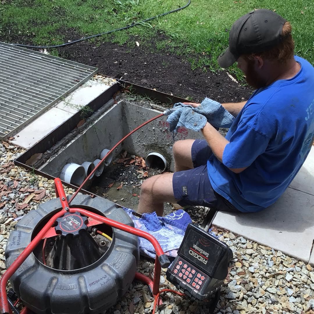 Coffs Harbour Jetty Plumbing team member repairing a blocked drain.