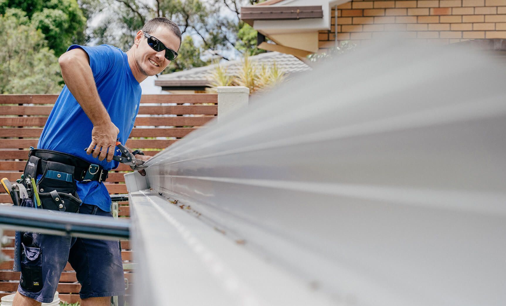 Jetty Plumbing team member about to cut some guttering for replacement