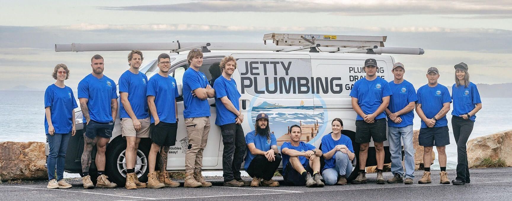 The Jetty Plumbing team standing outside their work vehicles in Coffs Harbour