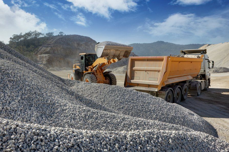 A Dump Truck is Being Loaded With Gravel at a Construction Site — Bennettron Demex in Evans Head, NSW