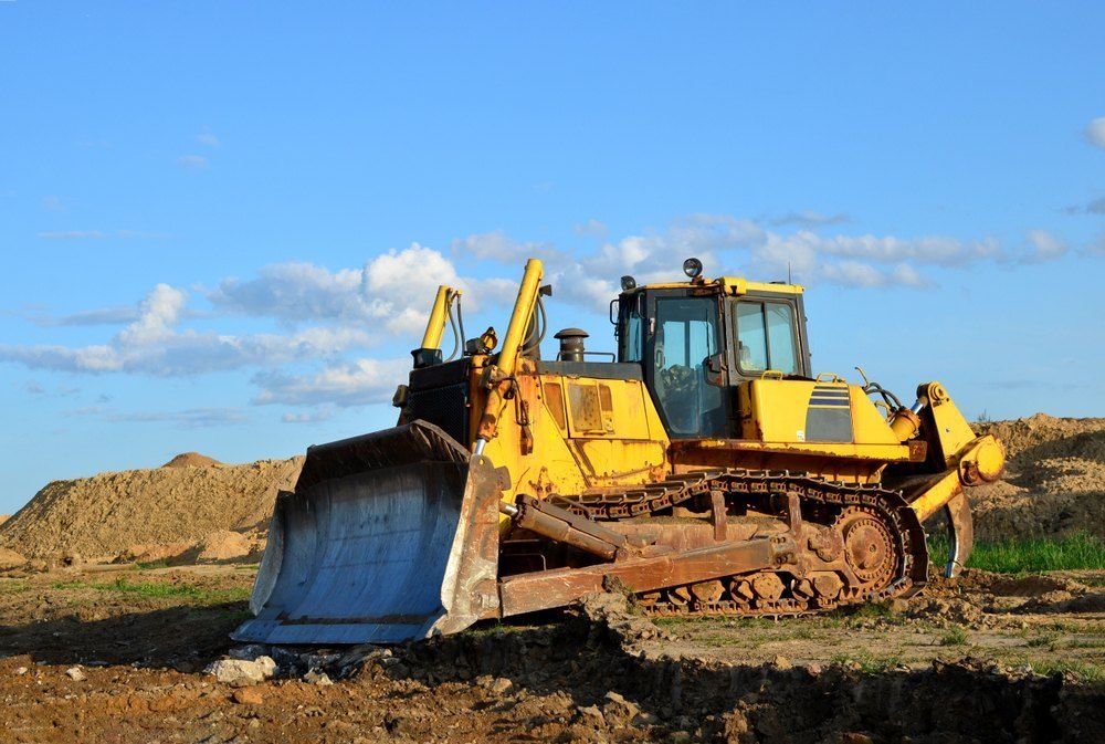 A Yellow Bulldozer is Sitting on Top of a Dirt Field — Bennettron Demex in Sawtell, NSW