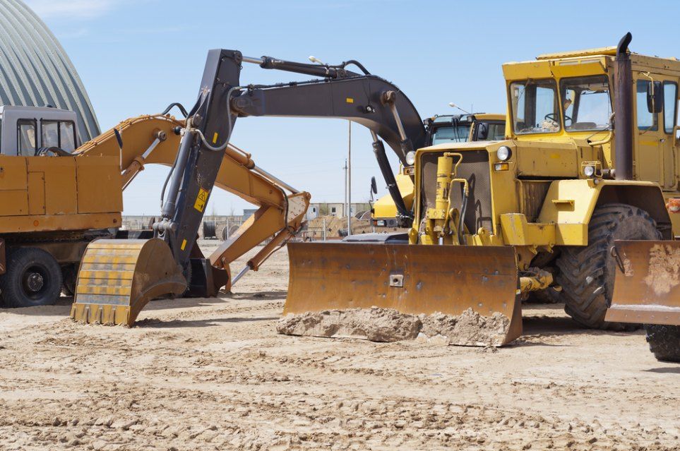 A Group of Construction Vehicles Are Parked on a Dirt Road — Bennettron Demex in Bonville, NSW