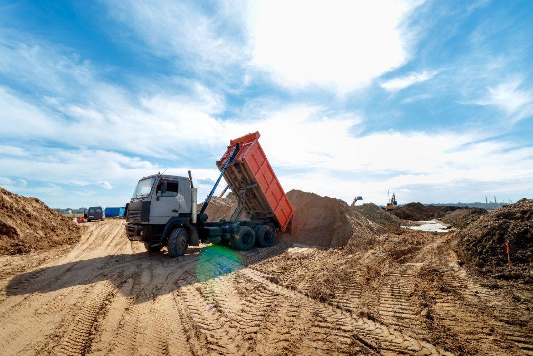 A Dump Truck is Dumping Sand on a Dirt Road — Bennettron Demex in Nambucca Heads, NSW