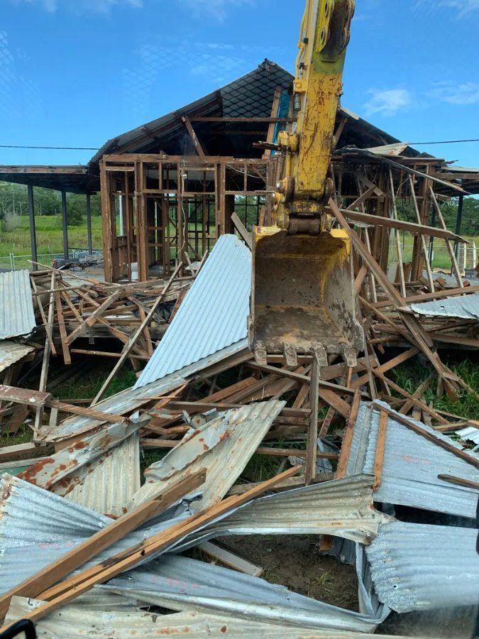 A House is Being Demolished by a Bulldozer — Bennettron Demex in Sawtell, NSW