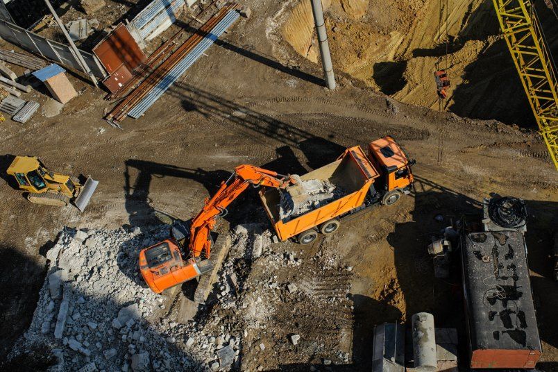 An Aerial View of a Construction Site With a Dump Truck and an Excavator — Bennettron Demex in Glen Innes, NSW