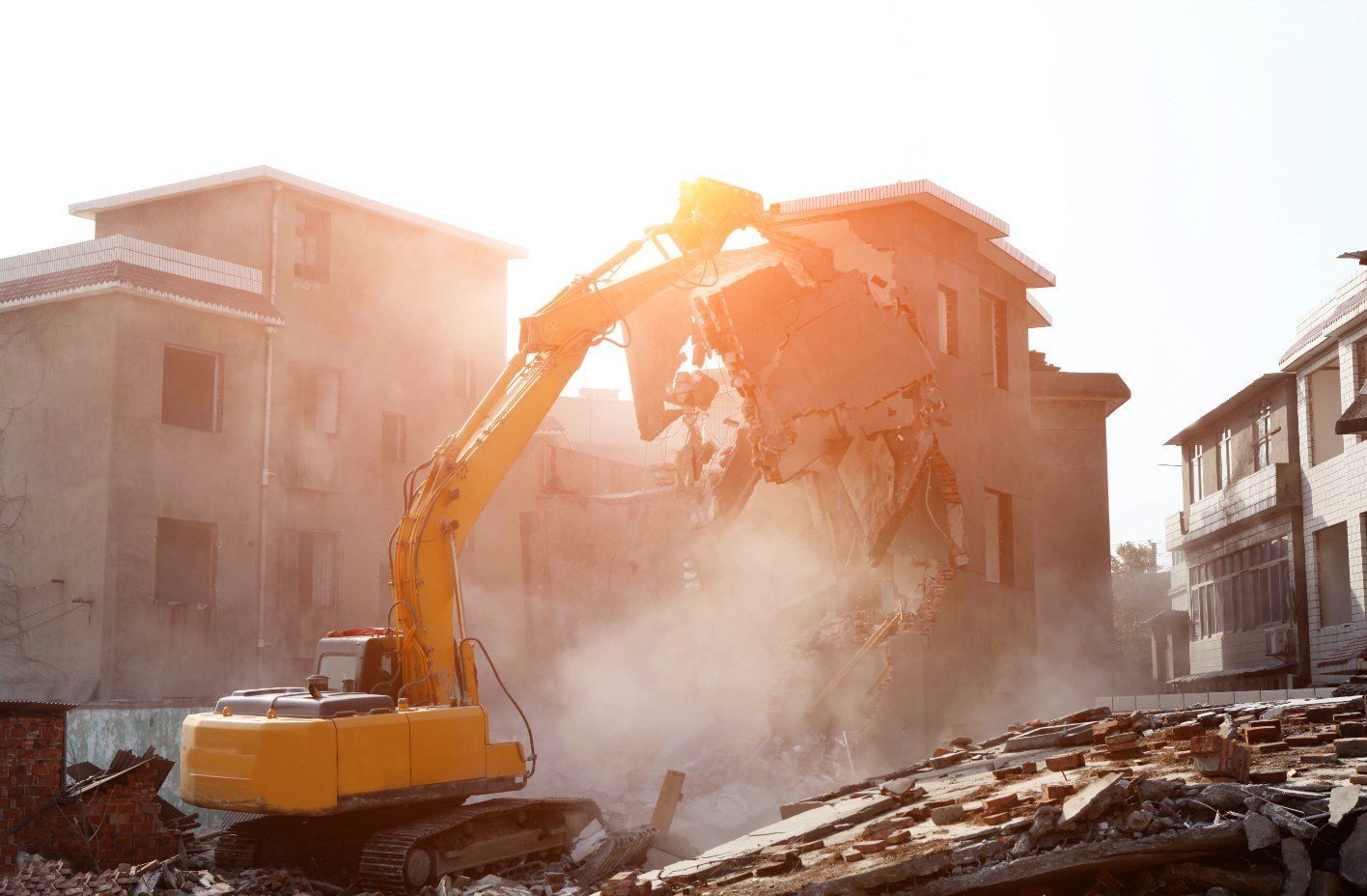 A Yellow Excavator is Demolishing a Building in a City — Bennettron Demex in Minnie Water, NSW