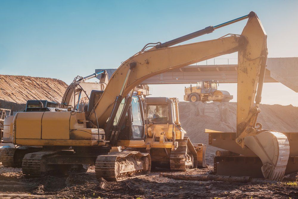 A Large Yellow Excavator is Working on a Construction Site — Bennettron Demex in Kempsey, NSW