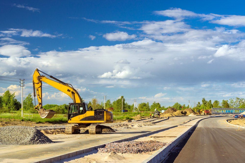 A yellow excavator is working on a construction site — Bennettron Demex in Corindi Beach, NSW