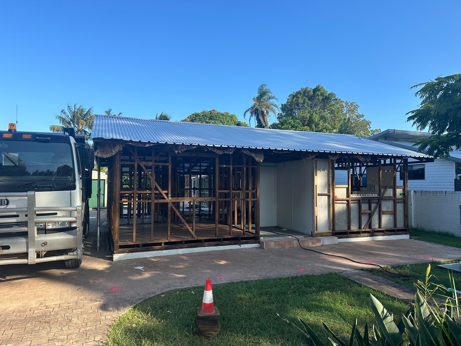 A house looks to be part built while truck is parked in driveway — Bennettron Demex in Corindi Beach, NSW