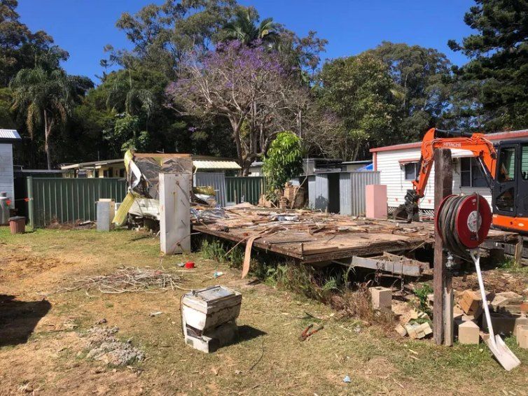 A House is Being Demolished in a Backyard With an Excavator — Bennettron Demex in Glen Innes, NSW