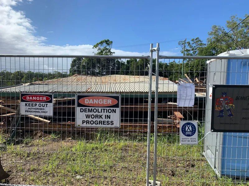 A Fence With a Danger Sign and a Demolition Work in Progress Sign on It — Bennettron Demex in Wauchope, NSW