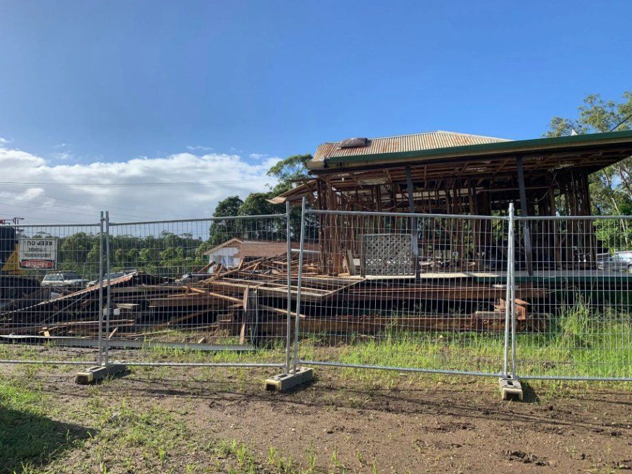 A House is Being Demolished and a Fence is Surrounding It — Bennettron Demex in Corindi Beach, NSW