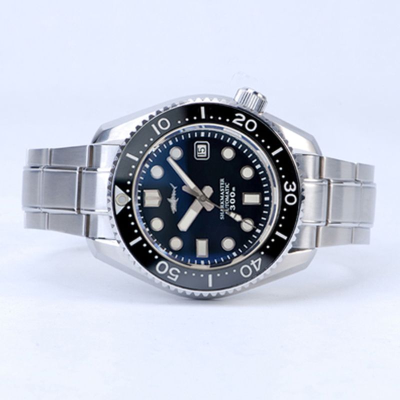 A silver watch with a black face has the number 20 on it