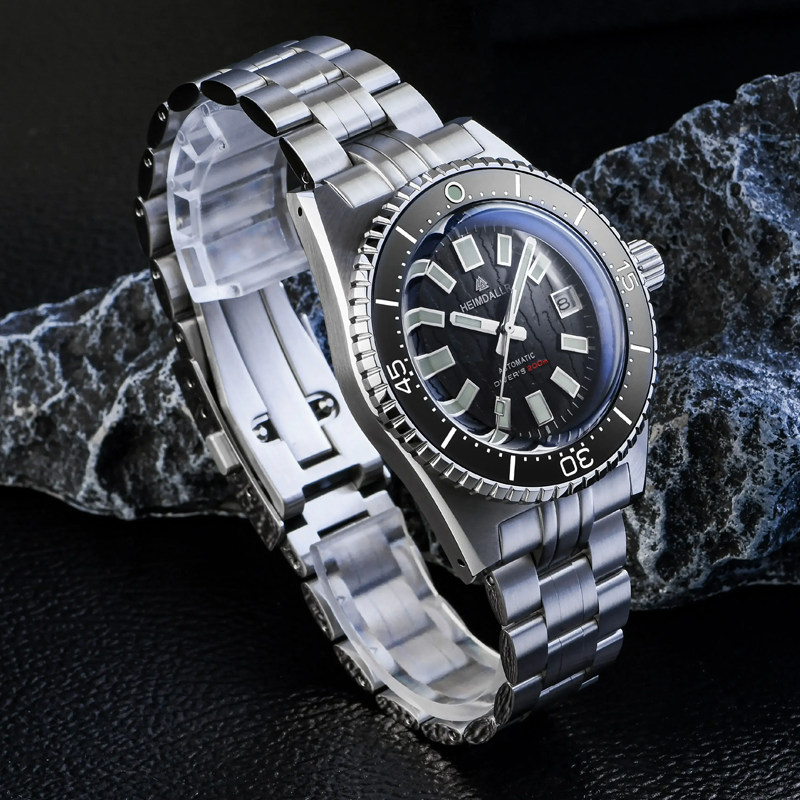 A silver watch with a black face is sitting on a rock