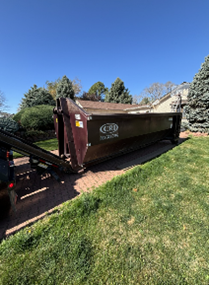 Roll-off dumpster placed in residential driveway.