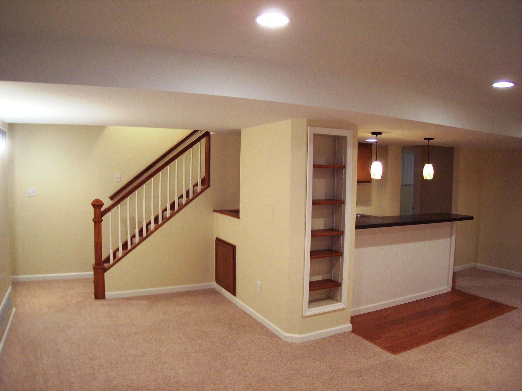 an empty basement with stairs leading up to the second floor