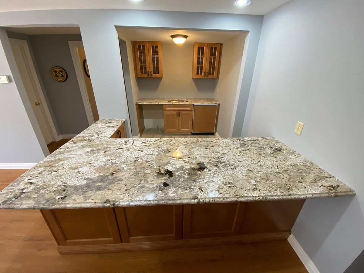 a kitchen with a granite counter top and wooden cabinets