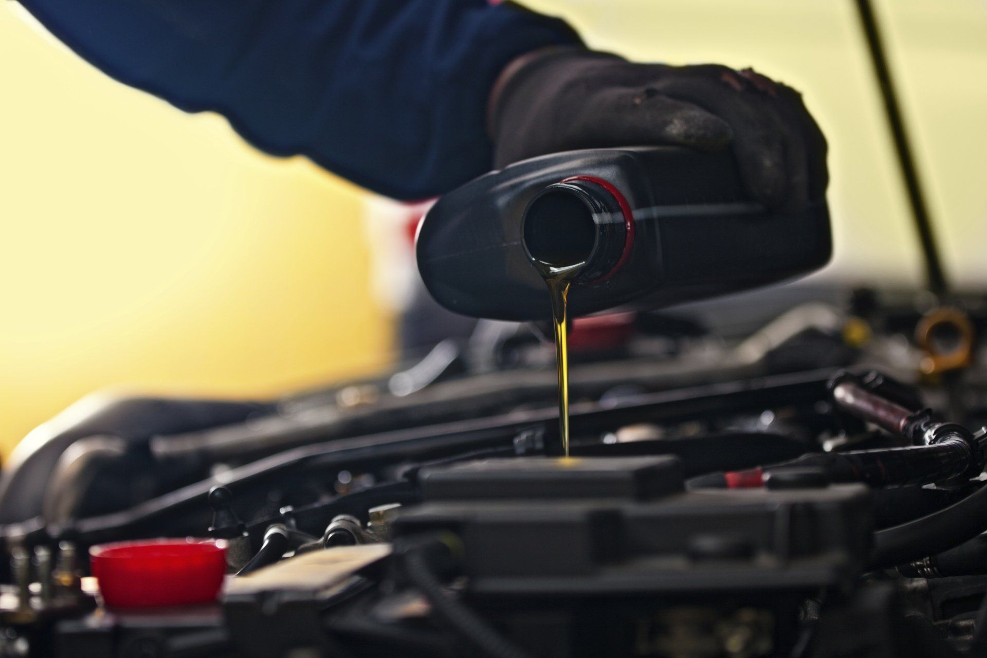 Mechanic Pouring Oil - Lubbock, TX - Wrench 'Em Auto & Diesel Repair