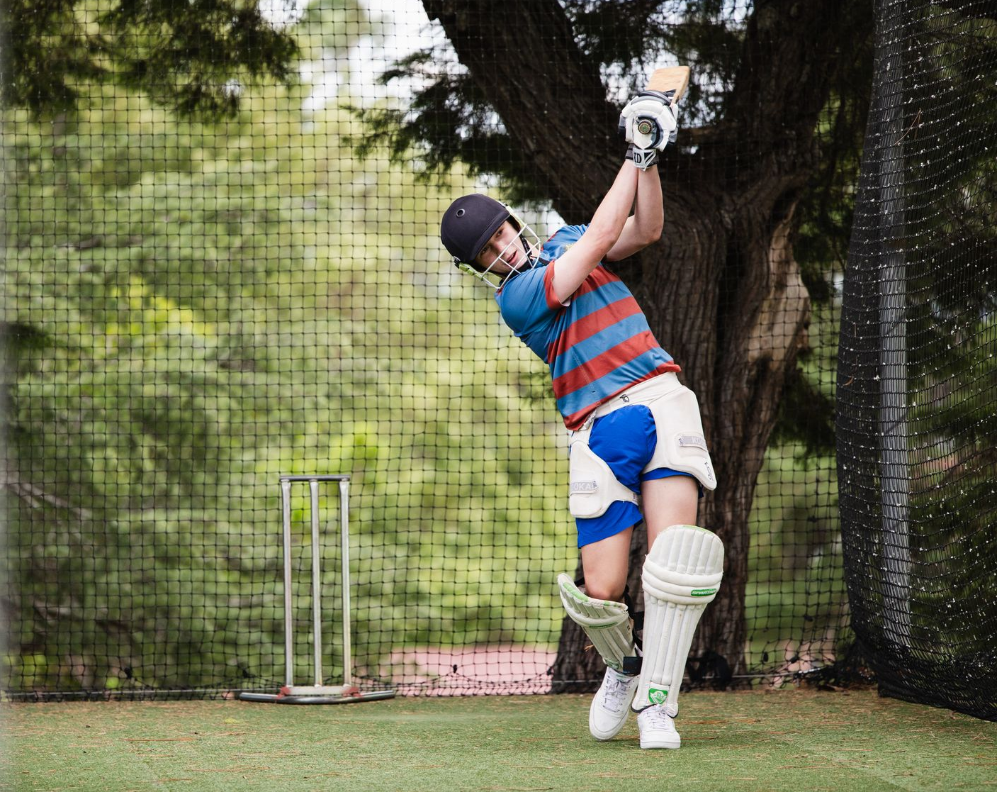 Student playing cricket.