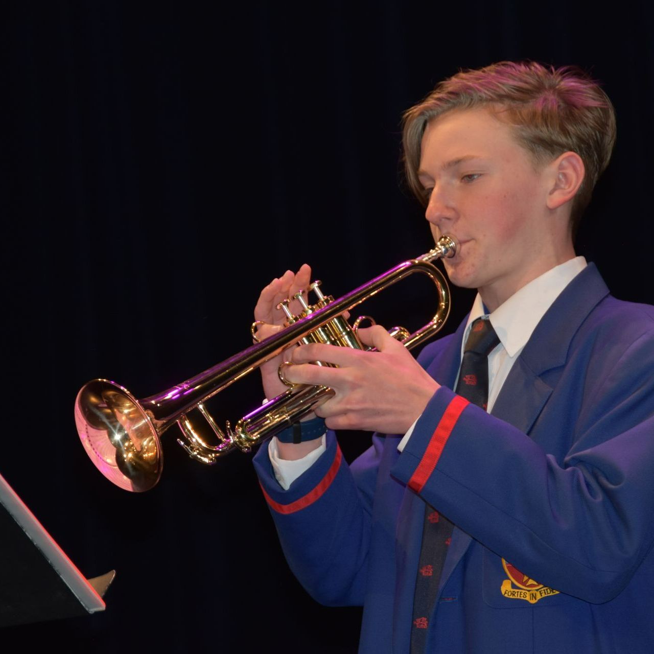 ͼ student playing the trumpet.