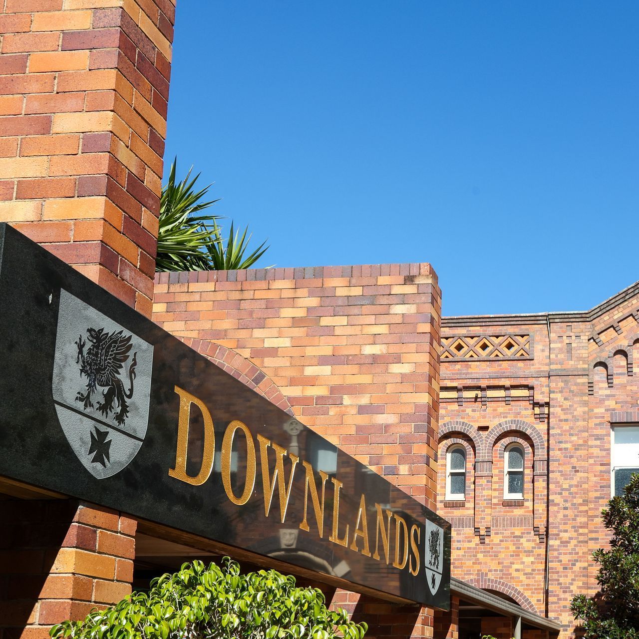 A brick building with a sign that says downlands