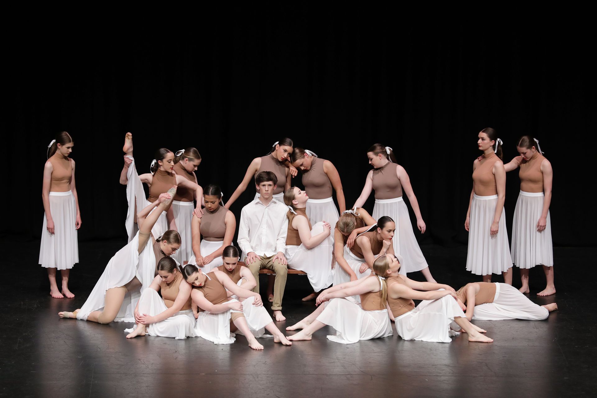 A group of dancers are standing on a stage.