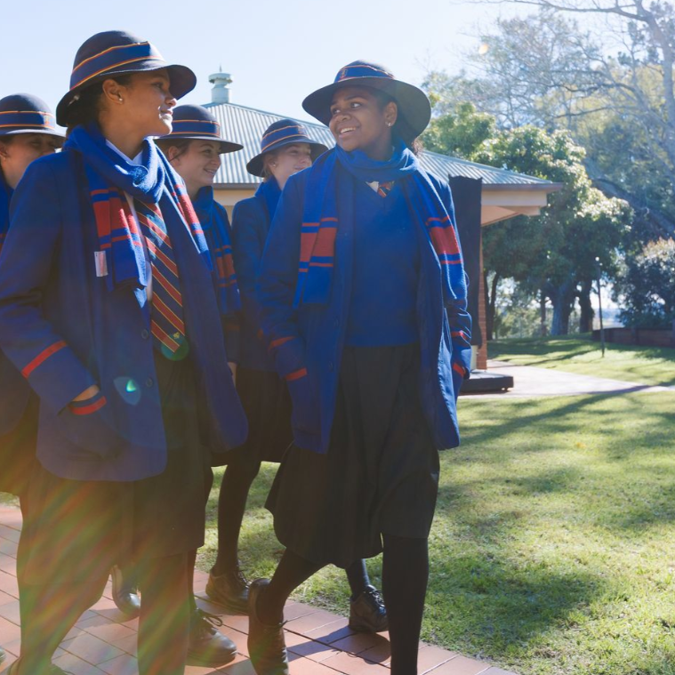 Student looking back to their friend smiling. 