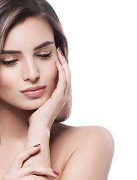 Woman touching face  - Hair Removal and Electrolysis in Franklin, MA