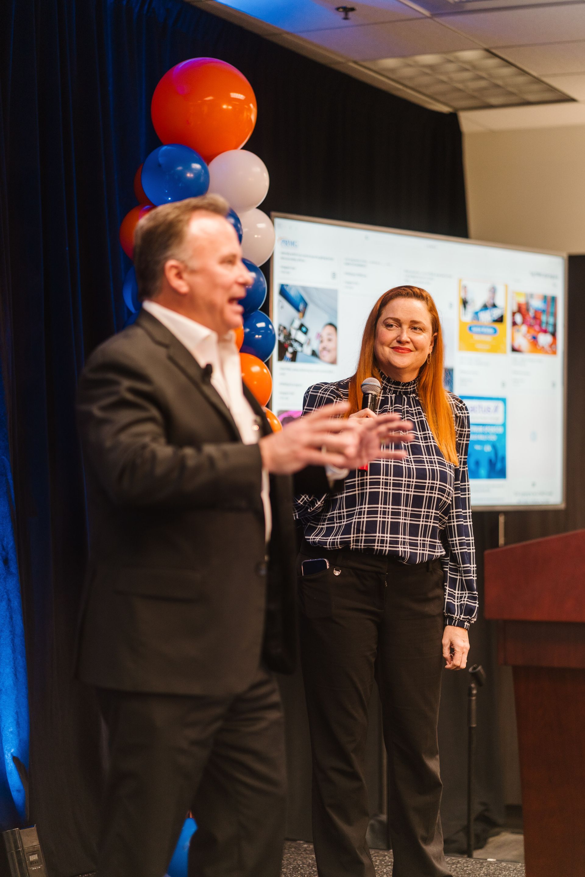 Robin Clayton shares the stage with PRMG executive Chris Sorensen.