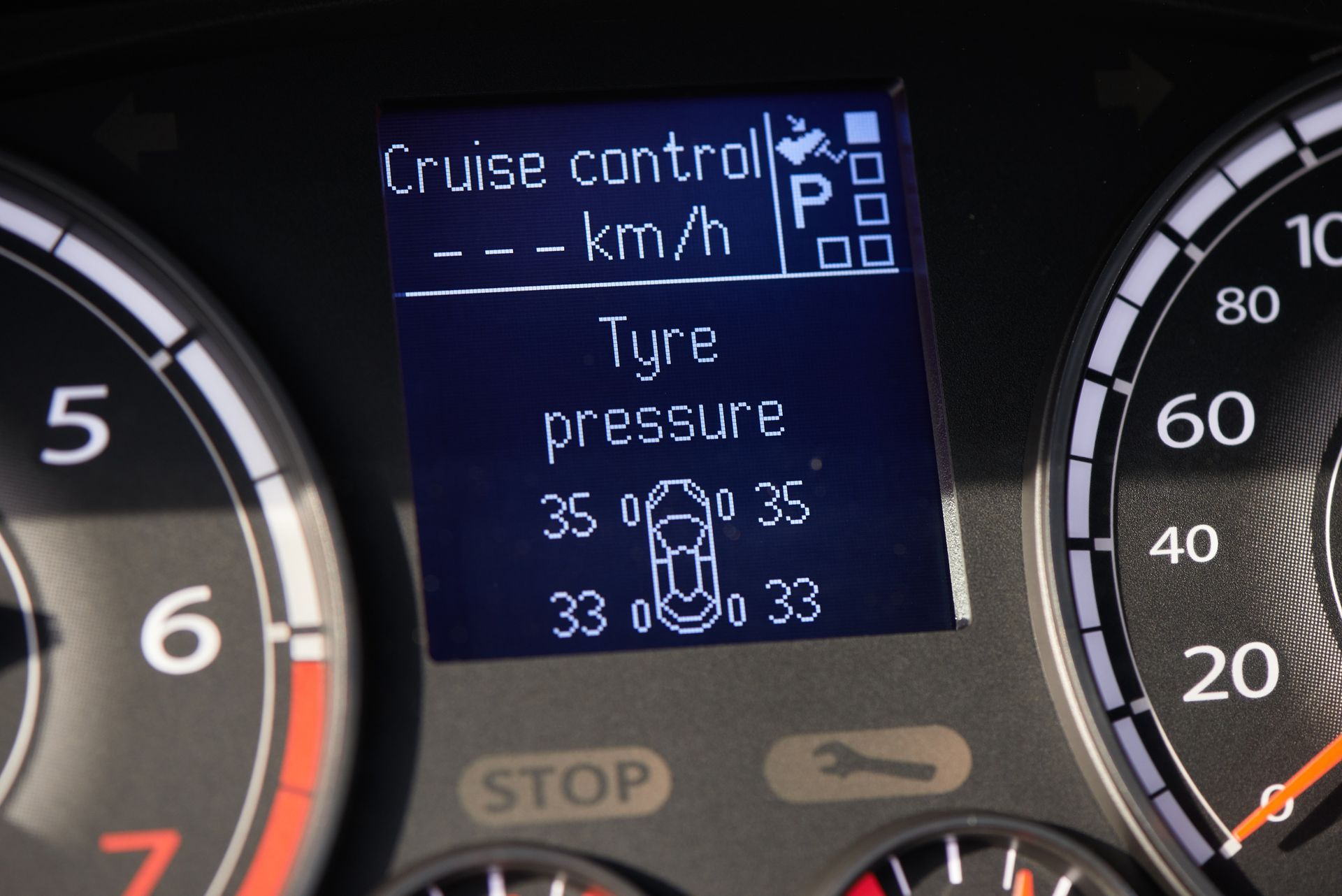 A close up of a car dashboard that says cruise control