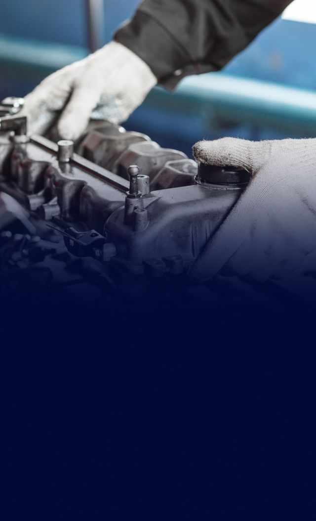 Mechanic in gloves working on a car engine. | Beach Auto Repair