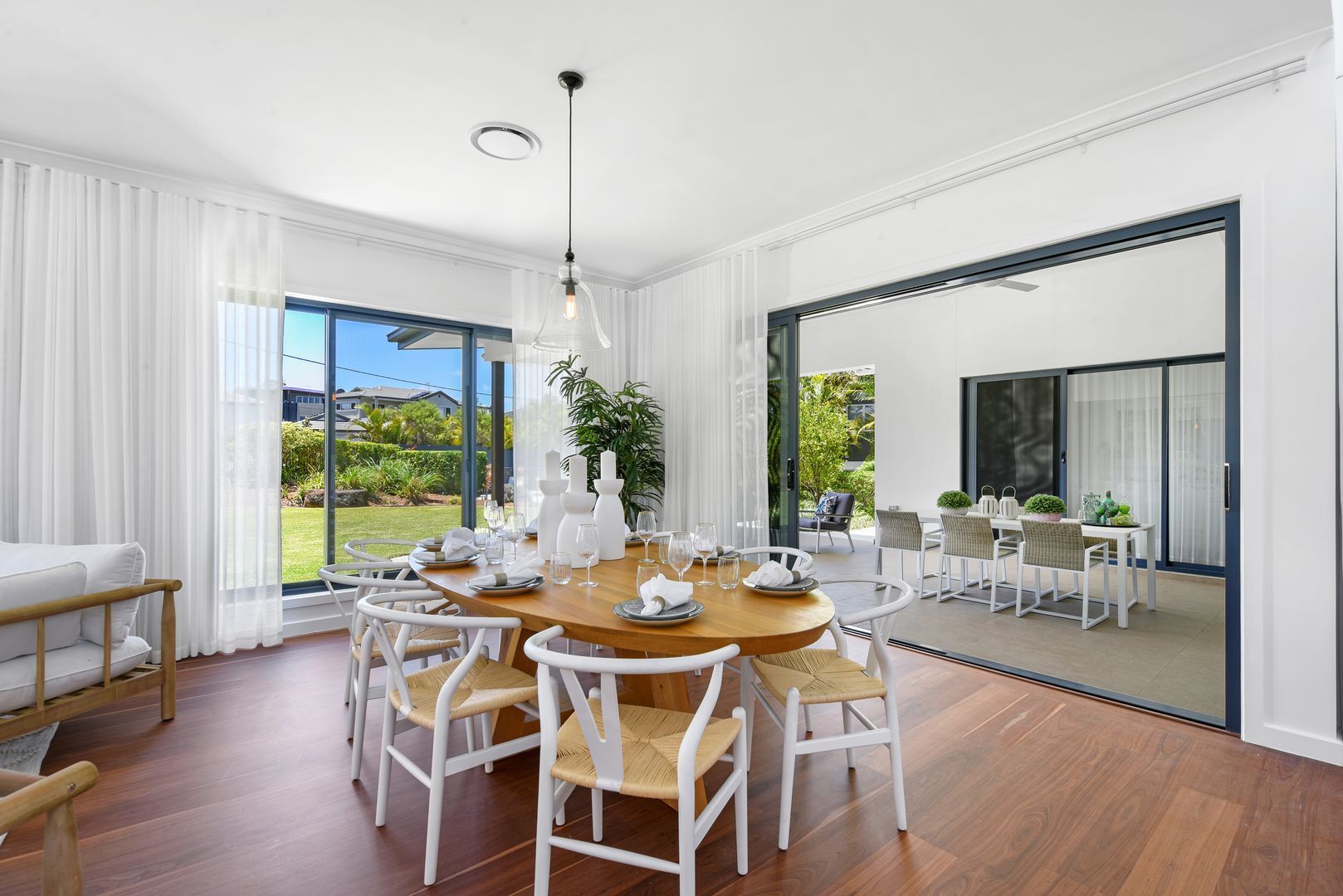 A large dining room with a round table and chairs.