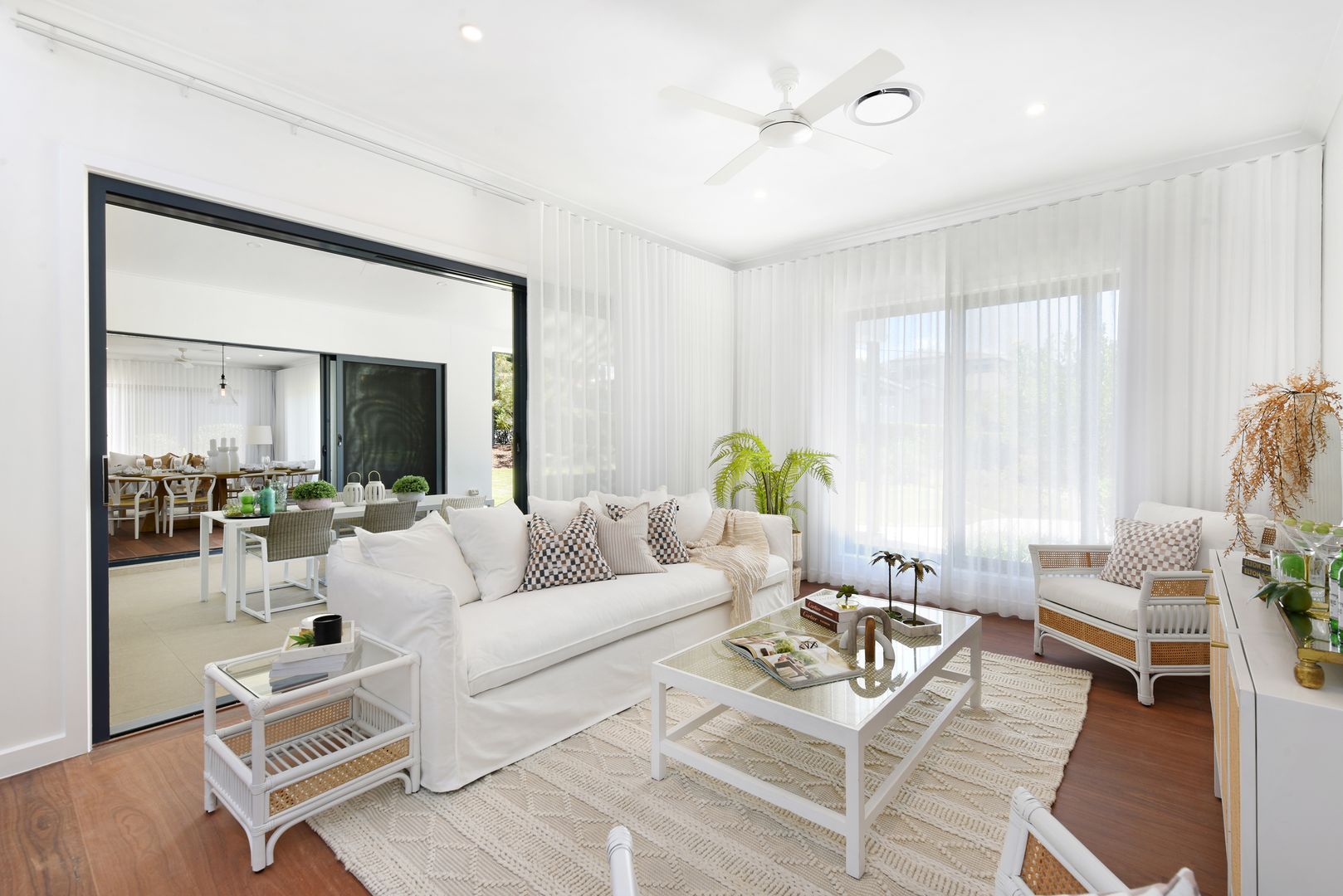 A living room filled with furniture and a ceiling fan.