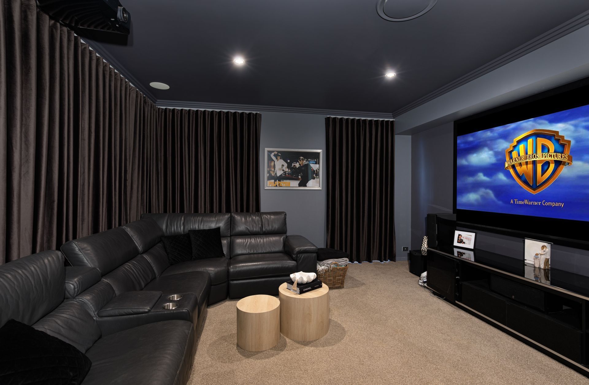 A home theater with a large screen that says warner bros on it