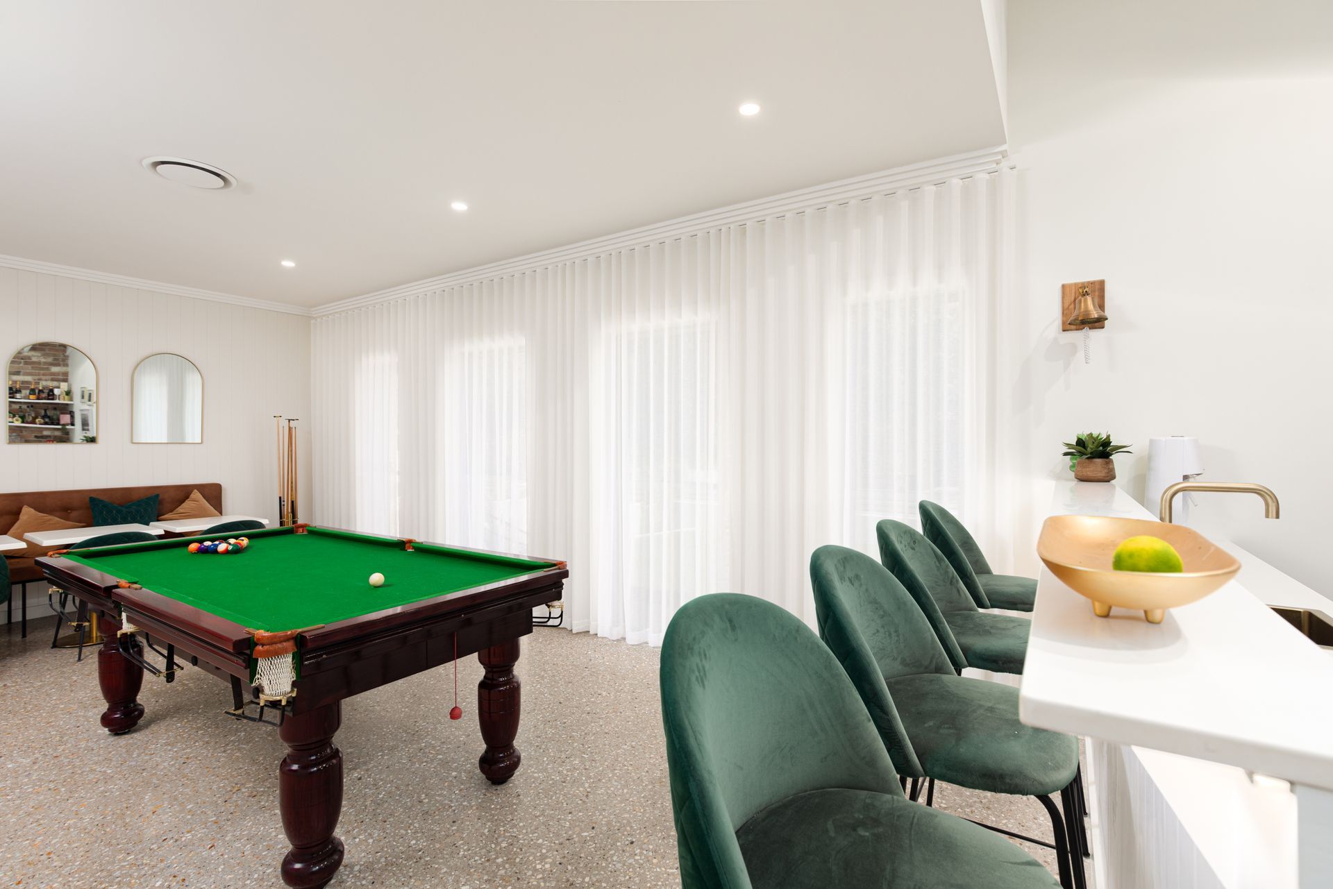 There is a pool table in the middle of the room.