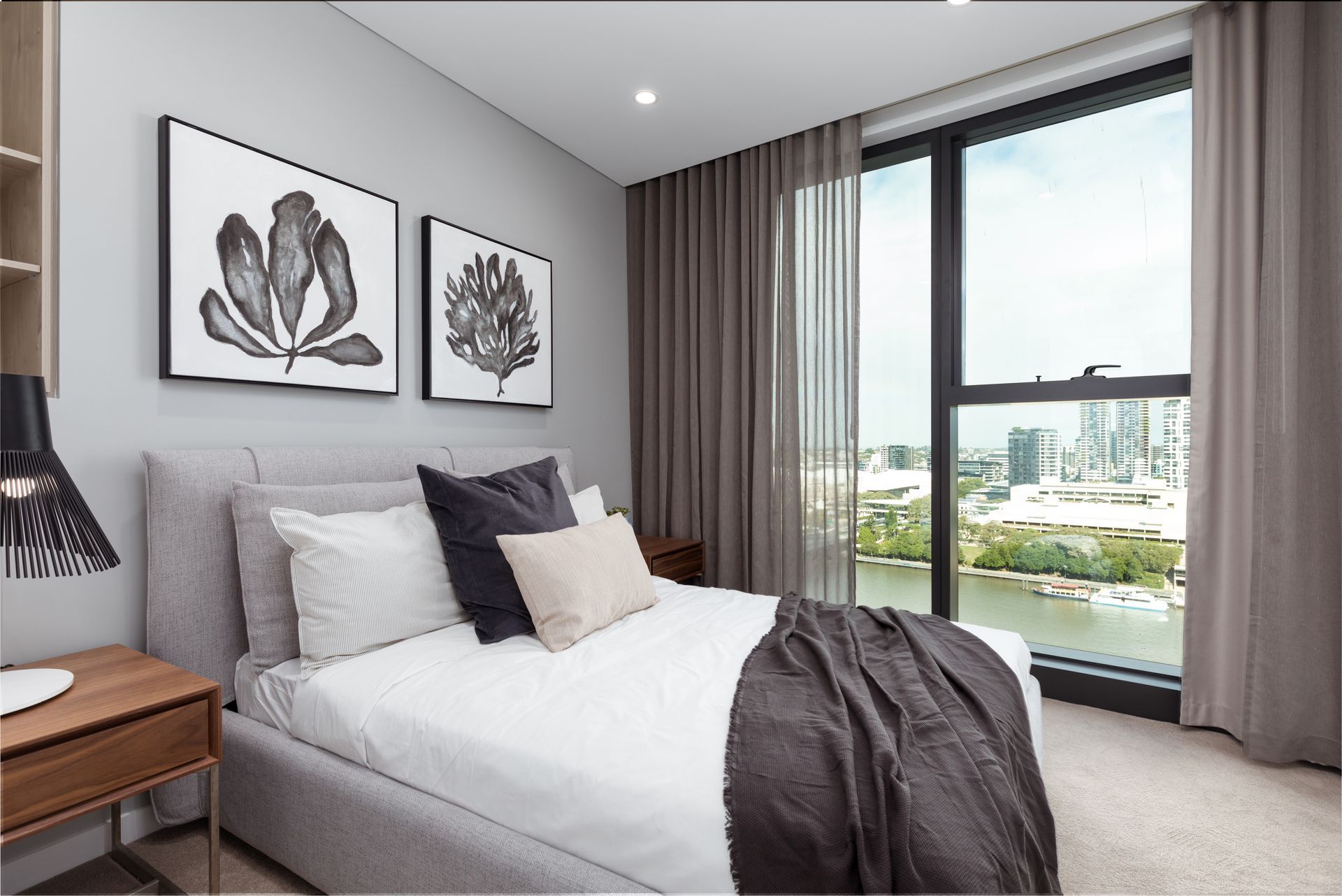 A bedroom with a large bed and a large window