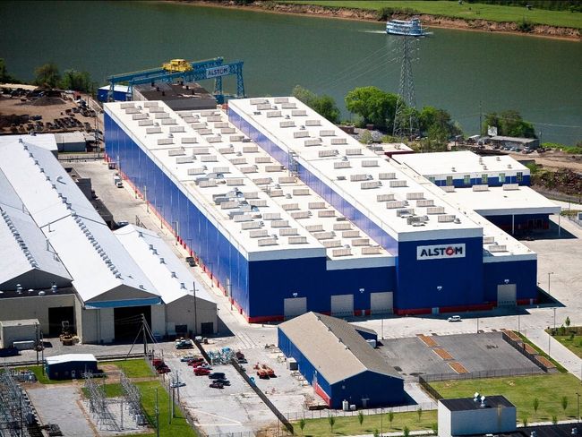 An aerial view of a large blue and white building that says alltor