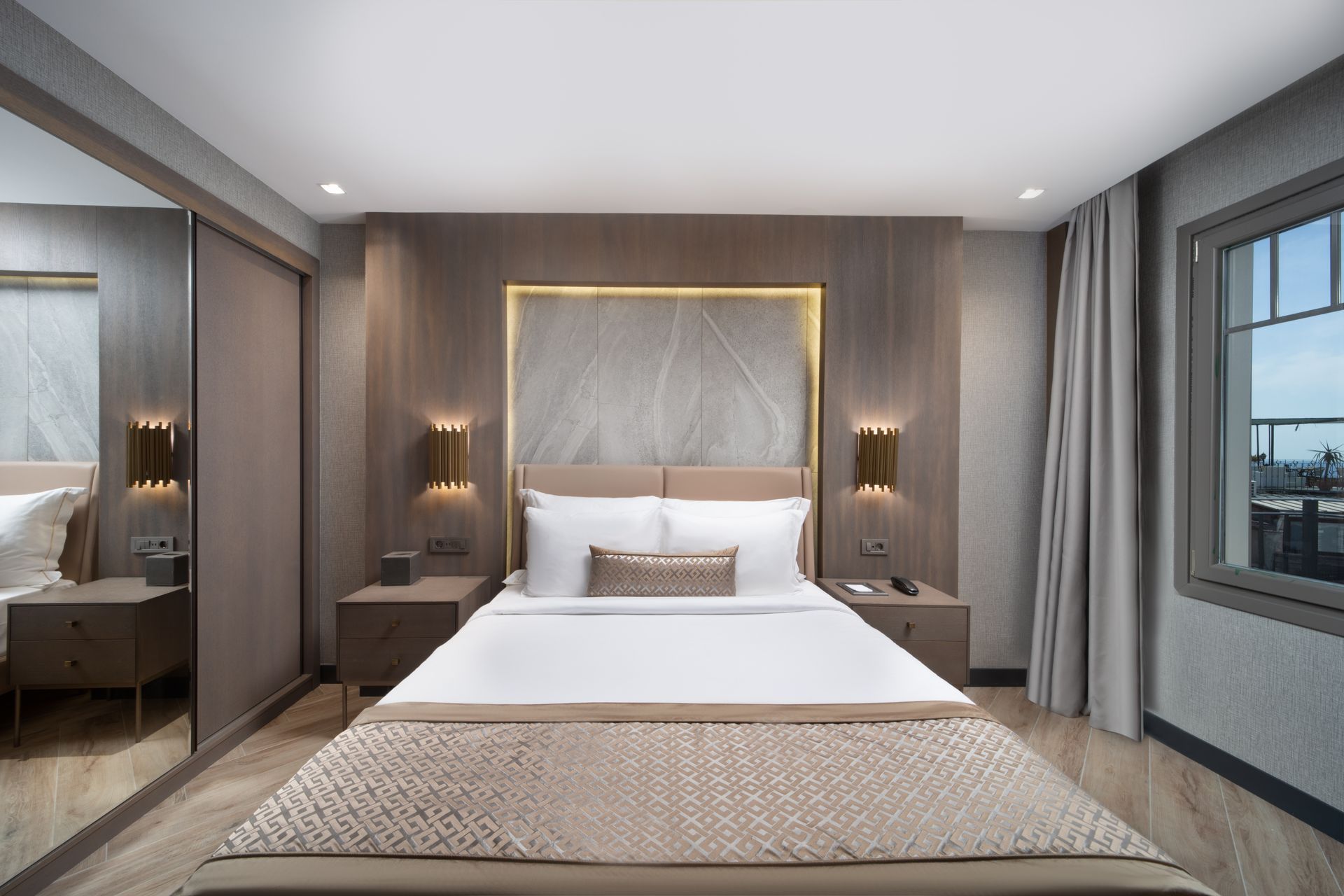 Mula Hotel | Hotel bedroom with a bed, nightstands, and window with a view.