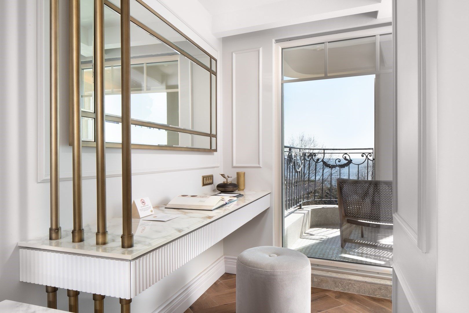 Mula Hotel | Vanity with mirror and balcony view; gold accents, white, and a sea view.