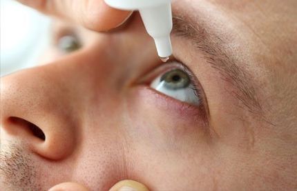 Man Putting Liquid Drops In His Eye — Oklahoma City, OK — Southwest Eye Clinic
