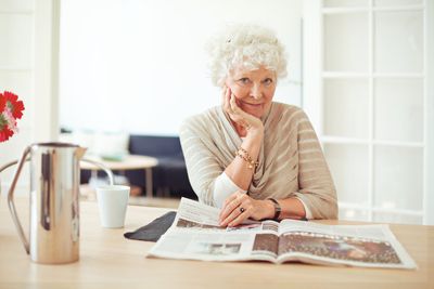 Older person reading a newspaper